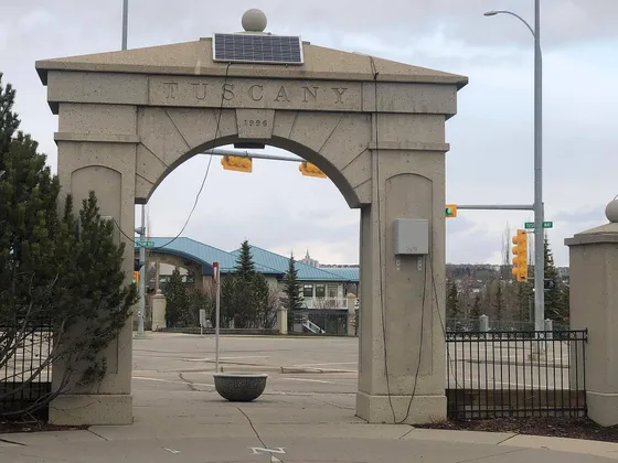 The stone entrance arch carved with the community name in Tuscany, northwest Calgary.